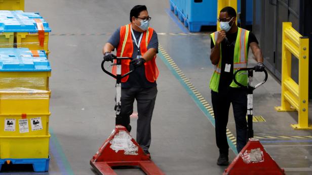 FILE PHOTO: Workers during operations at Amazon fulfillment center in Robbinsville New Jersey