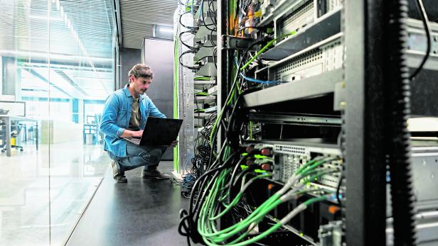 Computer technician fixing a network server at the office