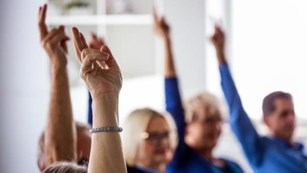 People voting during meeting in nursing home