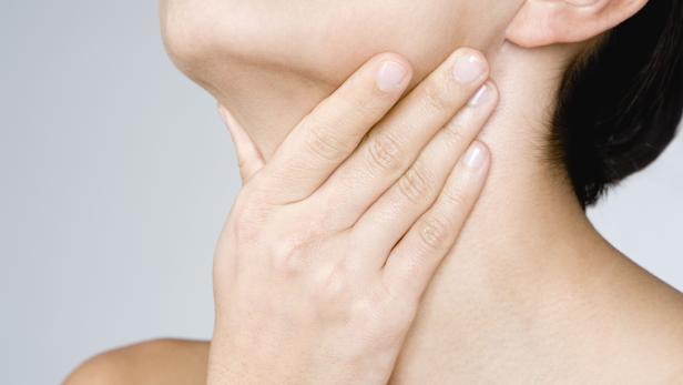 Woman touching her neck