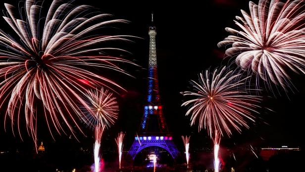 Fireworks explode around the Eiffel Tower during celebrations to mark Bastille Day, in Paris