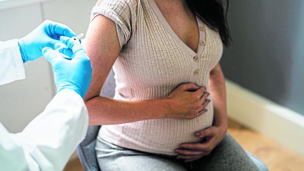 Doctor Making Covid-19 Vaccine Injection To Pregnant Woman