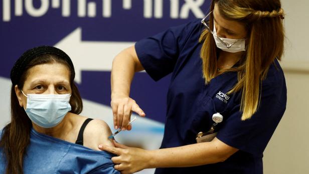 FILE PHOTO: People receive a fourth dose of coronavirus disease (COVID-19) vaccine after Israel's Health Ministry approved a second booster for the immunocompromised, in Ramat Gan