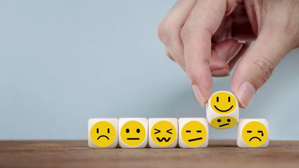 Hand Changing with smile emoticon icons face on Wooden Cube, hand flipping unhappy turning to happy symbol