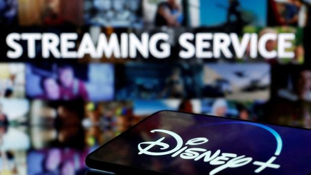 FILE PHOTO: A smartphone screen showing the "Disney+" logo is seen in front of the words "streaming service" in this illustration