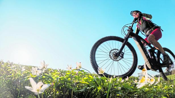 Woman on Mountain bike with blooming flowers