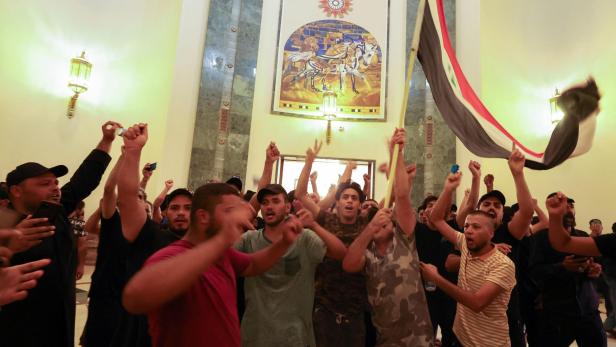 Supporters of Iraqi populist leader Moqtada al-Sadr protest inside the Green Zone, in Baghdad