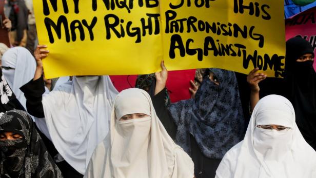 Women hold placards as they take a part in a protest in Lahore April 14, 2011, against the ban on full face veils in France. France&#039;s ban on full face veils, a first in Europe, went into force on Monday , exposing anyone who wears the Muslim niqab or burqa in public to fines of 150 euros ($216) and lessons in French citizenship. REUTERS/Mohsin Raza (PAKISTAN - Tags: POLITICS CIVIL UNREST)