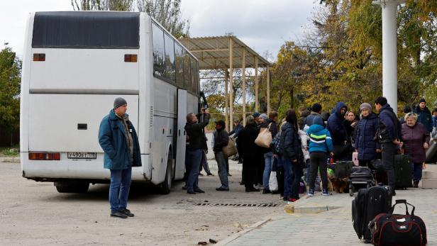 Civilians evacuated from Kherson board a bus in Oleshky