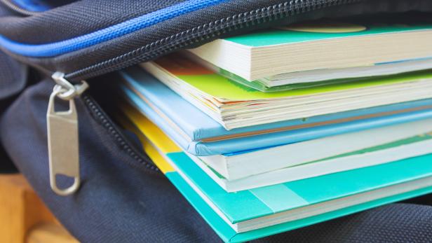 Textbooks in the school backpack, education concept.  Selective focus.