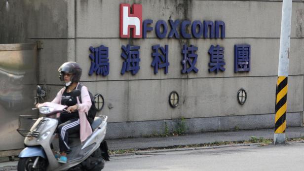 FILE PHOTO: A motorist passes by a Foxconn office building in Taipei, Taiwan