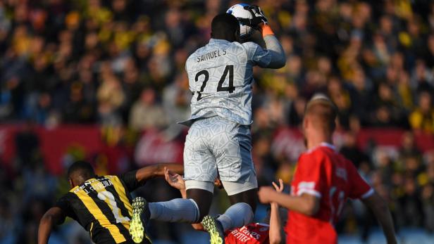 Ein Fußballtorwart fängt den Ball während eines Spiels zwischen Peñarol und Benfica.