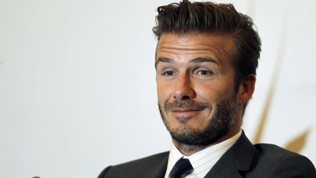 Former England soccer captain David Beckham smiles during a news conference in Shanghai June 20, 2013. Beckham arrived in China on Monday to start his second trip as China&#039;s soccer envoy. REUTERS/Aly Song (CHINA - Tags: SPORT HEADSHOT PROFILE ENTERTAINMENT SOCCER)