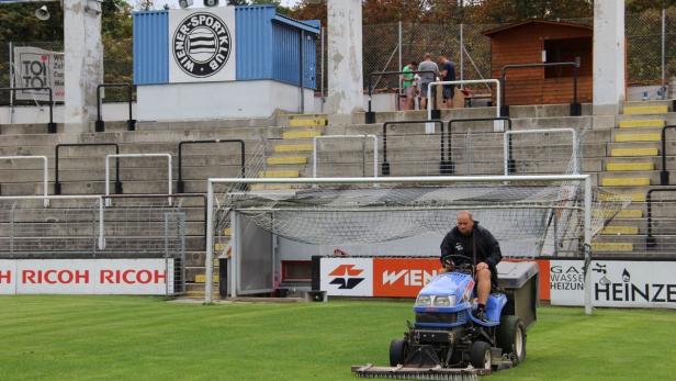 Ein Mann fährt einen Rasenmäher auf dem Fußballplatz des Wiener Sport-Club.