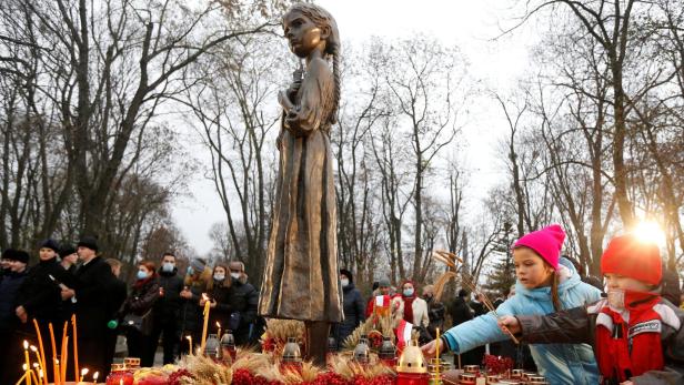 FILE PHOTO: People visit a monument to Holodomor victims in Kyiv