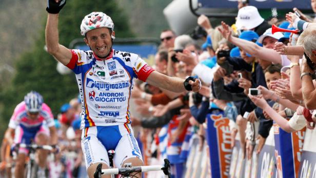 FILE PHOTO: Italy's Davide Rebellin celebrates after winning the Fleche Wallonne cycling race in Huy