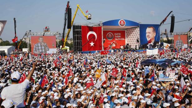 Turkish Prime Minister Tayyip Erdogan addresses his supporters during a rally by his ruling AK Party in Istanbul June 16, 2013. Erdogan rallied hundreds of thousands of supporters at an Istanbul parade ground on Sunday as riot police fired teargas several kilometres away in the city centre to disperse anti-government protesters. REUTERS/Murad Sezer (TURKEY - Tags: POLITICS CIVIL UNREST)