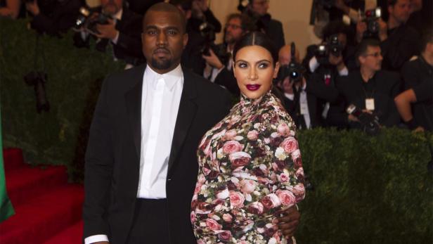 Singer Kanye West and reality television actress Kim Kardashian arrive at the Metropolitan Museum of Art Costume Institute Benefit celebrating the opening of &quot;PUNK: Chaos to Couture&quot; in New York, in this file picture taken May 6, 2013. Kardashian, 32, has given birth to a girl fathered by rapper West, celebrity magazines People and Us Weekly reported on June 15, 2013. People magazine said Kardashian gave birth on June 15 ahead of schedule, with the baby reportedly due in early July. REUTERS/Lucas Jackson/Files (UNITED STATES - Tags: ENTERTAINMENT)