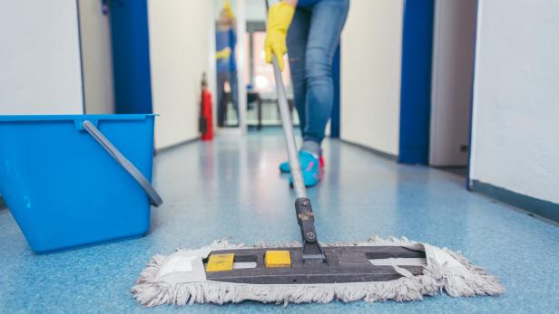 Close-up of cleaners moping the floor