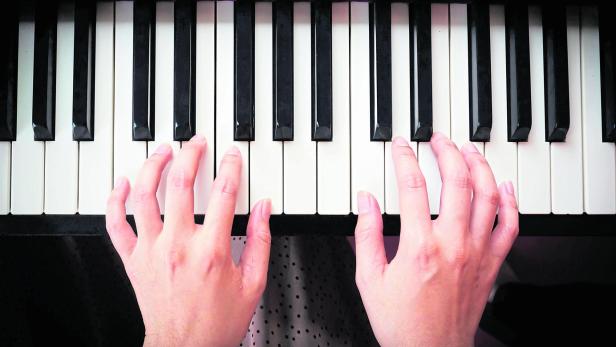 Woman's hand playing piano.