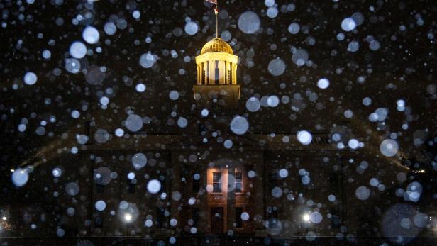 Snow falls during a winter storm warning at the Old Capitol Building in Iowa City