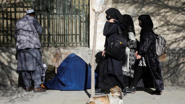 Afghan female students walk near Kabul University in Kabul