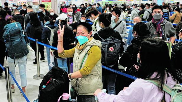 A woman celebrates at Hong Kong's Lok Ma Chau border checkpoint on the first day China reopens the border amid the COVID-19 pandemic in Hong Kong