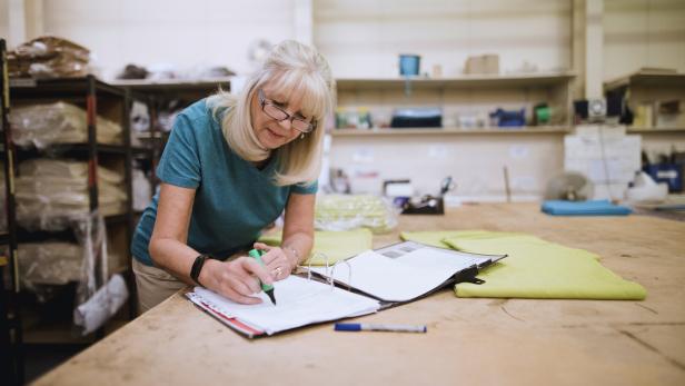 Businesswoman Doing Paperwork In Factory