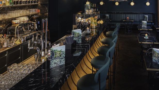 Innenansicht des Restaurants „Maria und Josef“ mit Bar und Sitzplätzen.