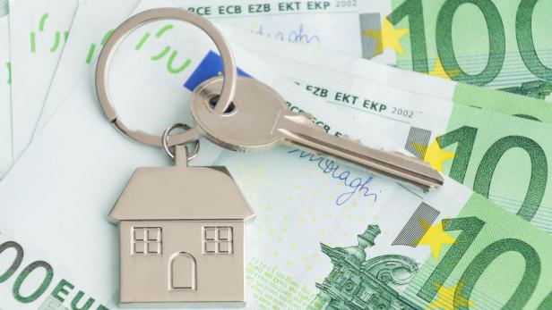 Home keys and a small house on currencies euro background. The concept of renting or selling house or flat, mortgage, investment or real estate, property buying. Money for the housing plan