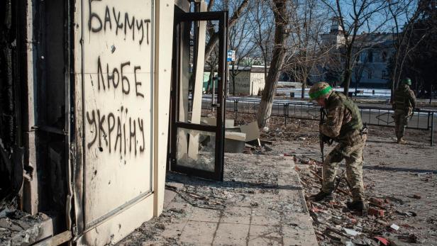 Ukrainian service member checks the damage of a building in the frontline town of Bakhmut
