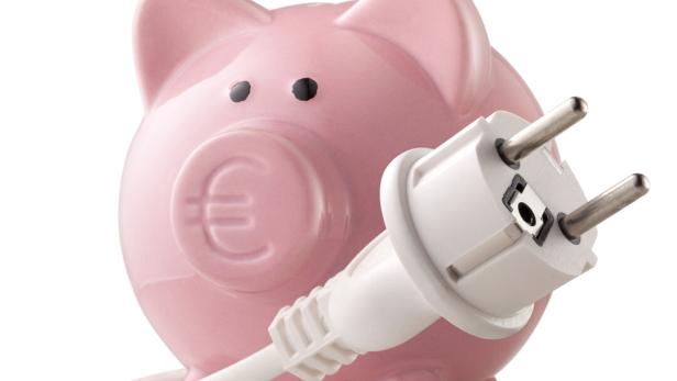 Piggy bank with euro symbol and electric plug