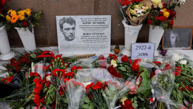 People lay flowers in memory of Russian opposition politician Boris Nemtsov in Moscow