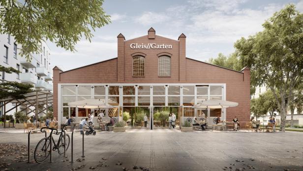 Das Restaurant „Gleis//Garten“ mit Gästen im Außenbereich an einem sonnigen Tag.