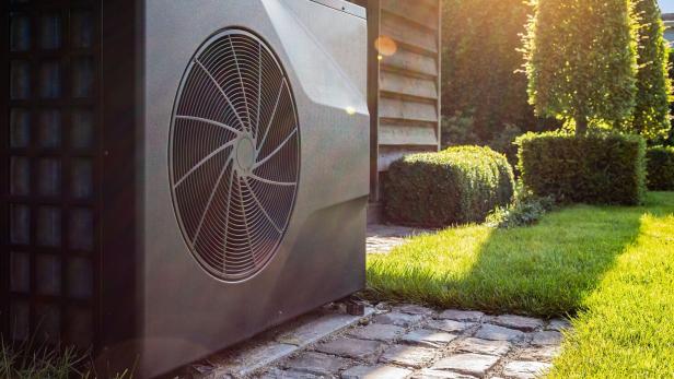 Air heat pump near pool house outdoors.