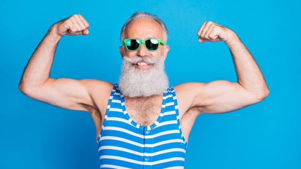 Close-up portrait of his he nice attractive content proud sportive cheerful cheery gray-haired man trainer instructor showing biceps isolated on bright vivid shine turquoise blue green background