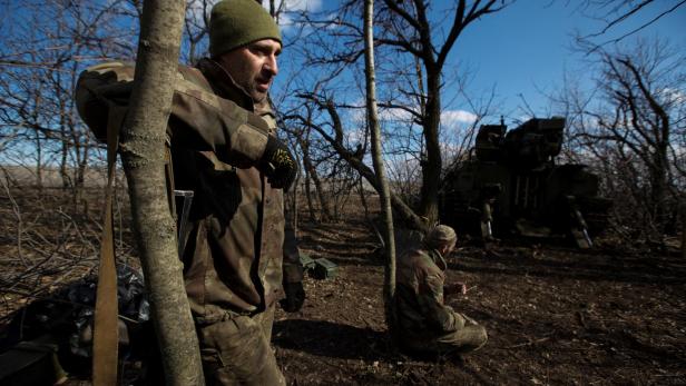 Ukrainian servicemen are seen near a 2S5 Giatsint-S self-propelled howitzer outside the frontline town of Bakhmut