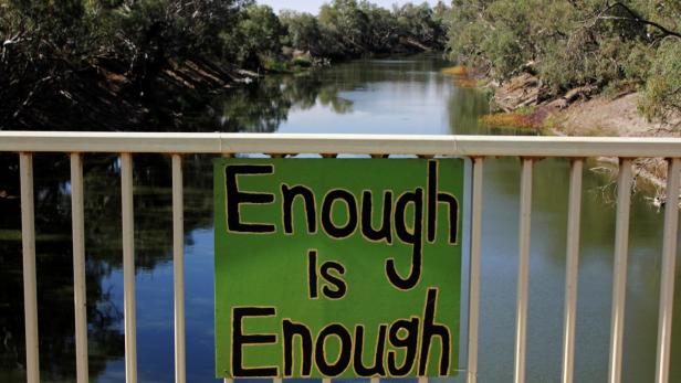FILE PHOTO: A sign protesting against government management of water allocation is seen on a bridge over the drying-up Darling River at Menindee