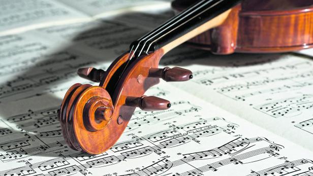 Up close of a violin on a music sheet