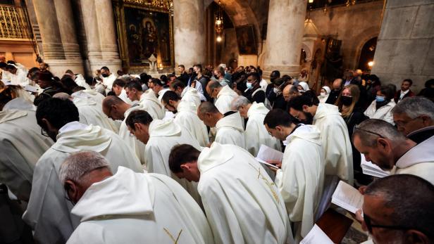 Members of the clergy and worshippers take part in the Catholic Washing of the Feet ceremony on Easter Holy Week in the Church of the Holy Sepulchre in Jerusalem's Old City