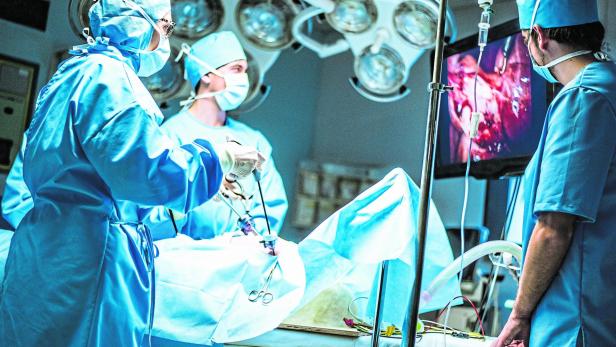 Three surgeons doing laparoscopic surgery