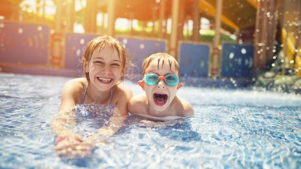 Brother and sister having fun in water park