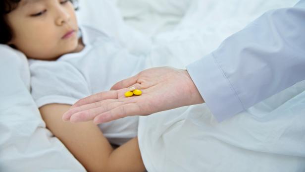 Sick boy taking medicine