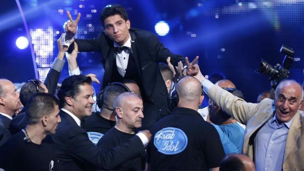 Palestinian singer Mohammed Assaf reacts after being announced winner of the Season 2 finale of &quot;Arab Idol&quot; in Zouk Mosbeh area, north of Beirut June 22, 2013. REUTERS/Mohammed Azakir (LEBANON - Tags: ENTERTAINMENT)