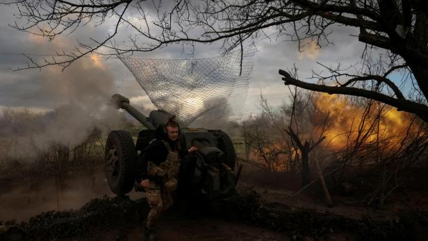 FILE PHOTO: Ukrainian service members fire a howitzer D30 at a front line near the city of Bakhmut