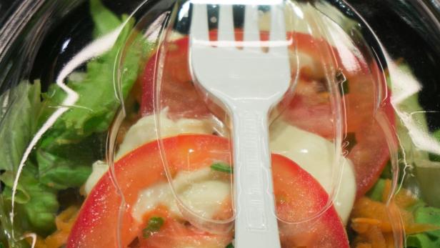 packed caprese salad with white fork
