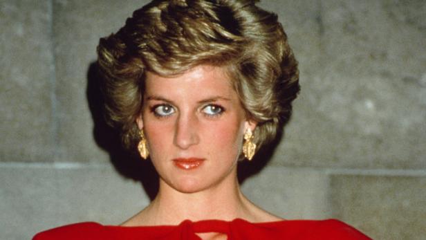 Diana, Prinzessin von Wales, in einem roten Kleid und goldenen Ohrringen.