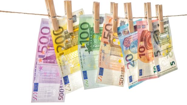 Money background. Euro banknotes hanging clothes pins