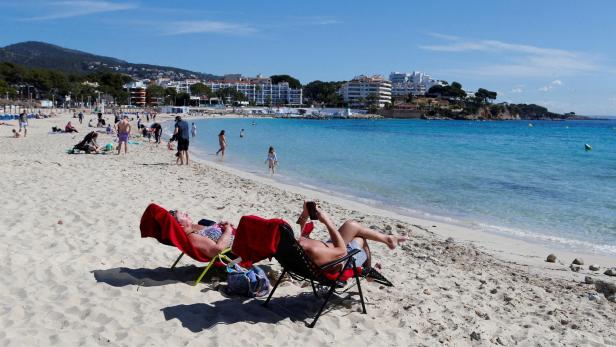 FILE PHOTO: People enjoy the sunny weather on the Balearic island of Mallorca