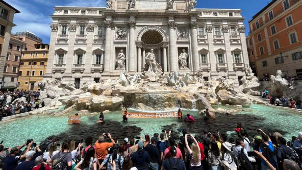 Climate activists pour black liquid into Rome's Trevi Fountain